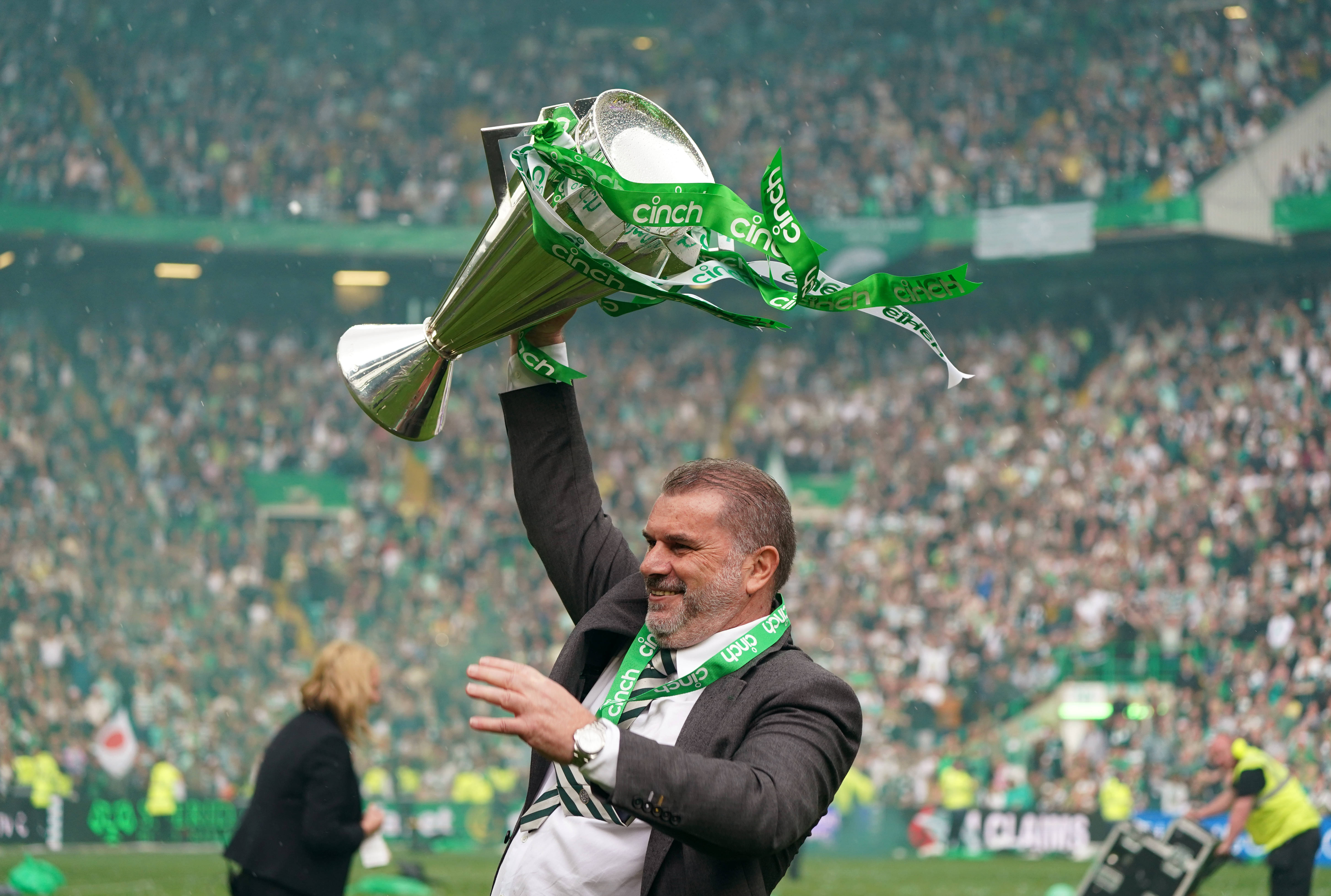 Ange Postecoglou celebrates with the league trophy 