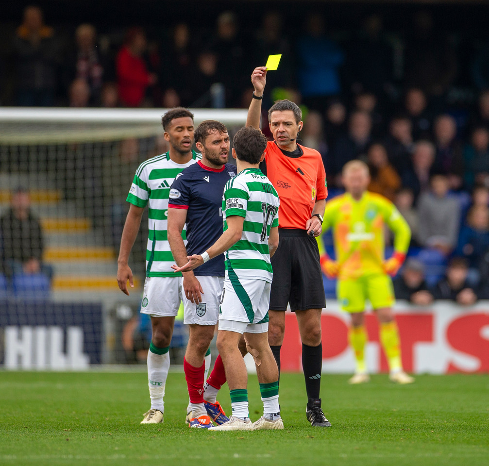 Nicolas Kuhn receives a yellow card from referee Kevin Clancy