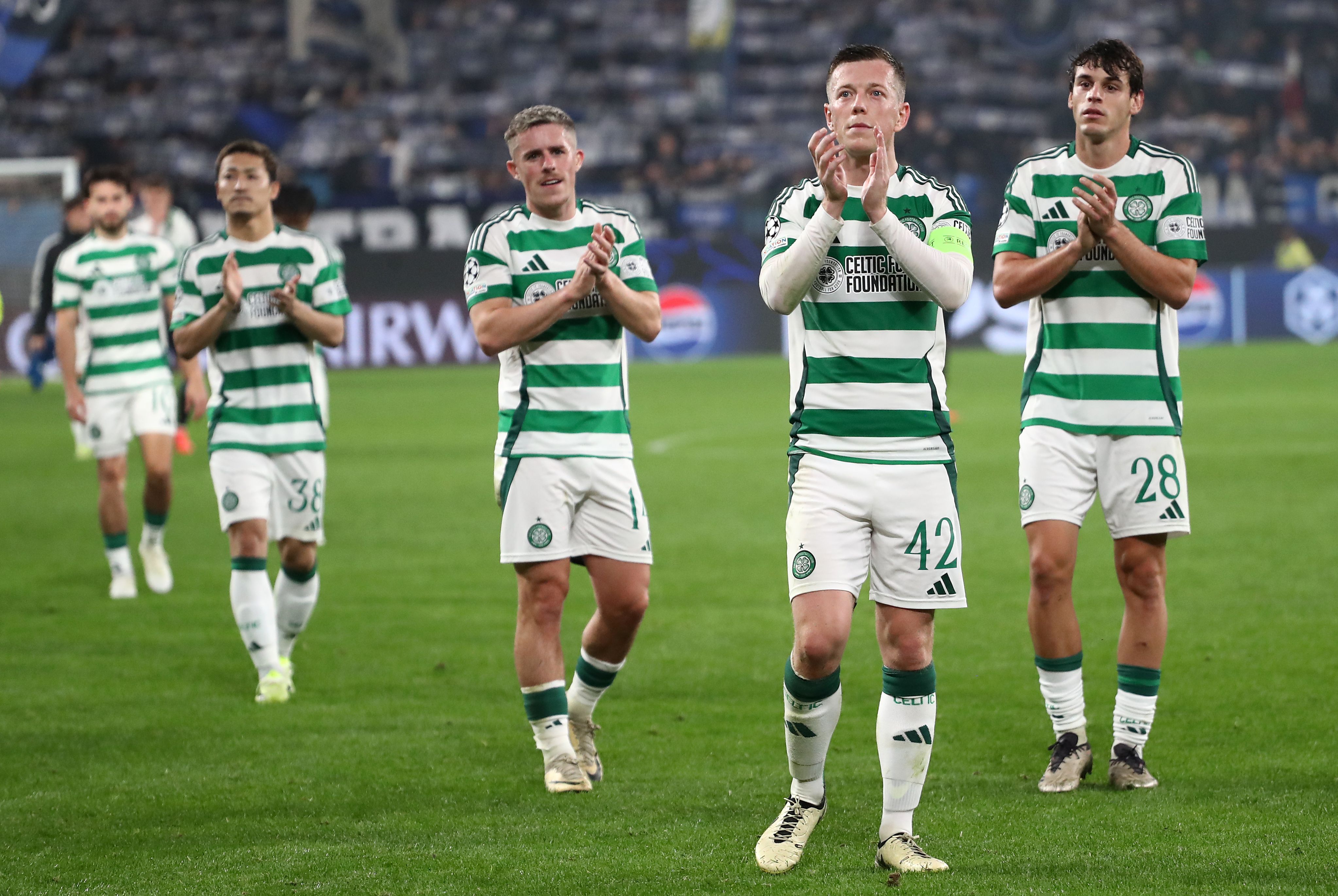 Callum McGregor applauds the fans