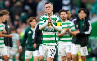 Callum McGregor applauds the fans