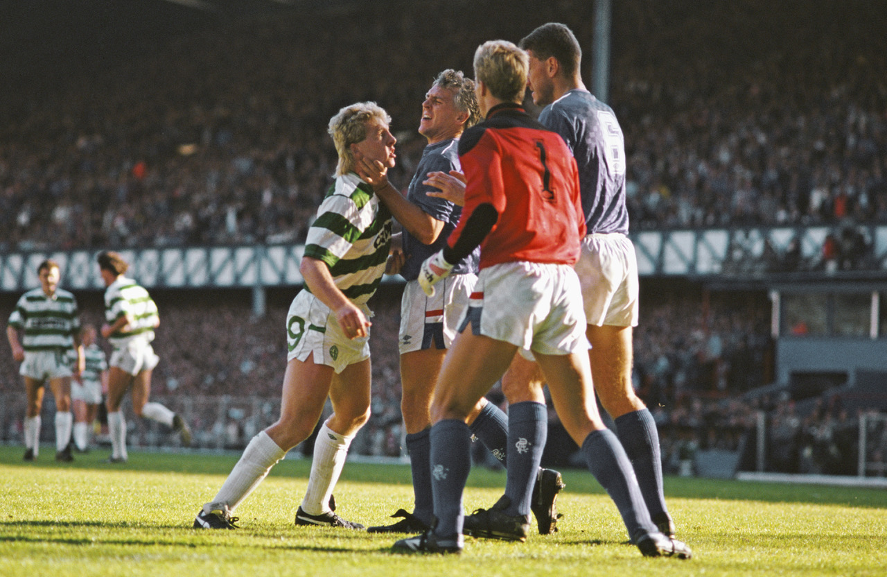 Frank McAvennie is held by the throat