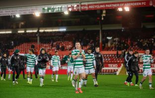 Alistair Johnston leads the Celtic players to applaud the fans