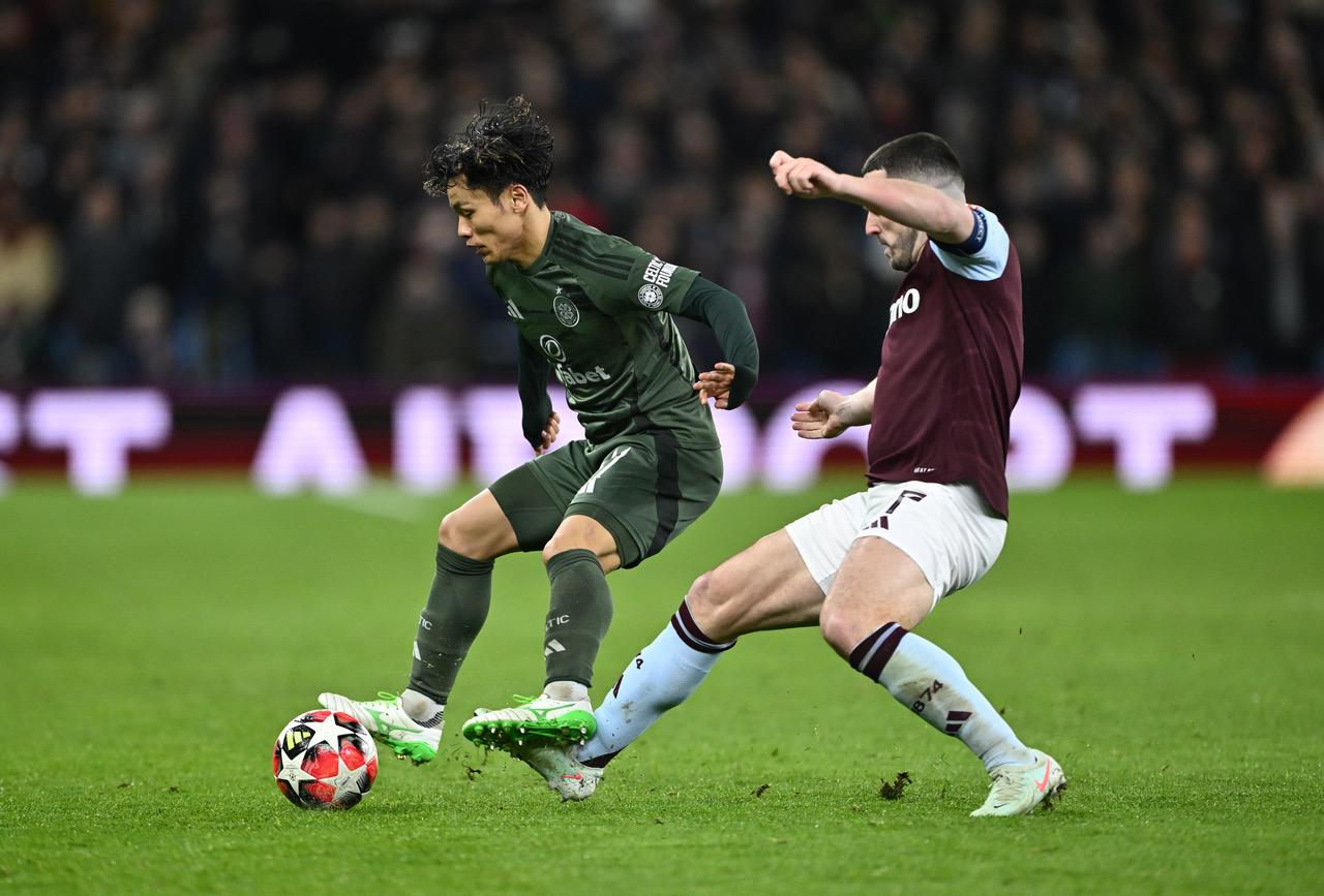 Reo Hatate and John McGinn battle for the ball