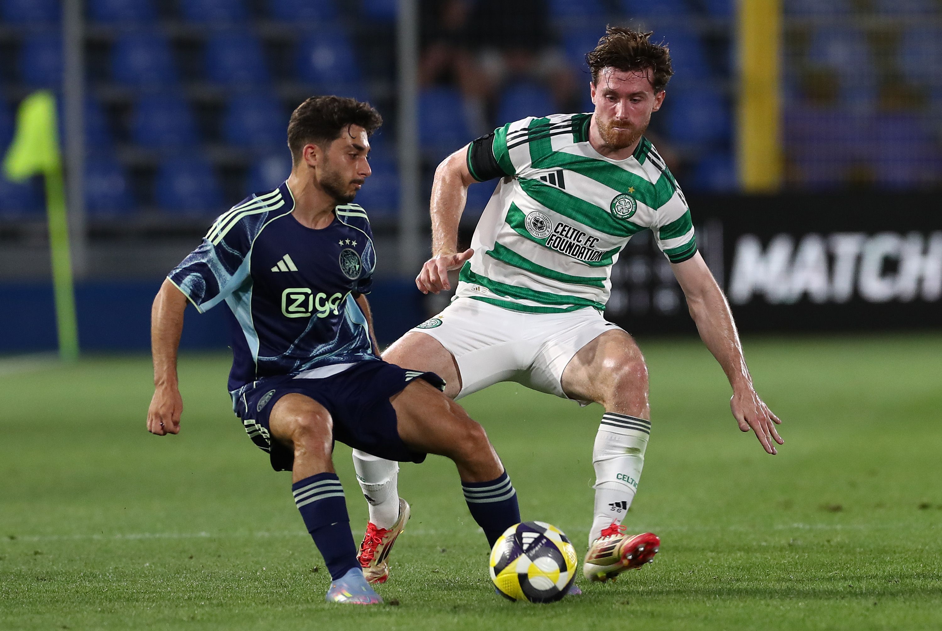 Raul Moro of Ajax competes for the ball with Anthony Ralston