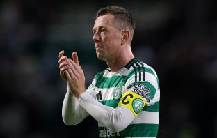 Callum McGregor applauds the fans