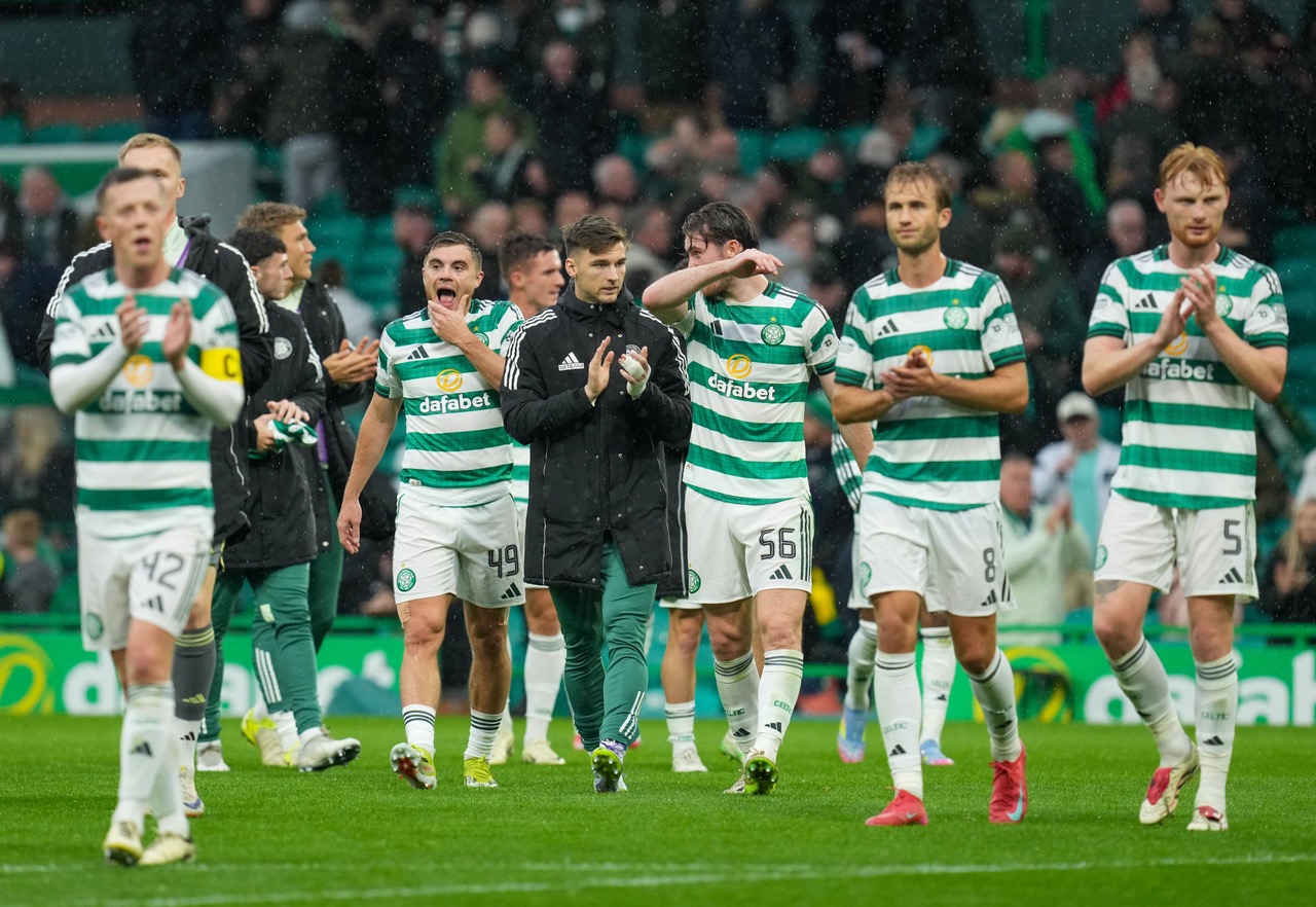 Celtic players applaud the support