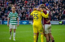 Hearts players celebrate as a dejected Liam Scales looks on