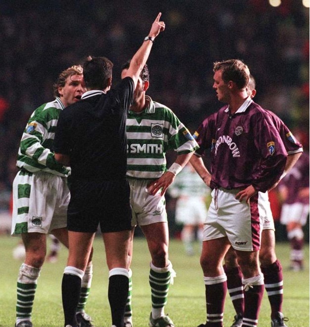 30/11/96 - CELTIC V HEARTS (2-2) Paolo Di Canio is ushered from the field by manager Tommy Burns (right) after receiving a red card following an altercation with Hearts midfielder Steve Fulton. Photo The Celtic Wiki