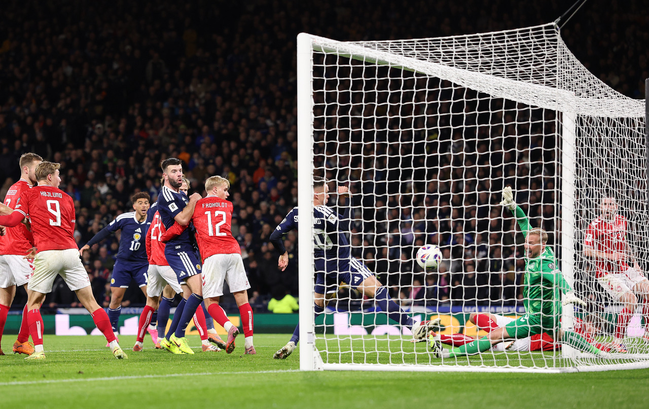 Kasper Schmeichel of Denmark is beaten by Lawrence Shankland