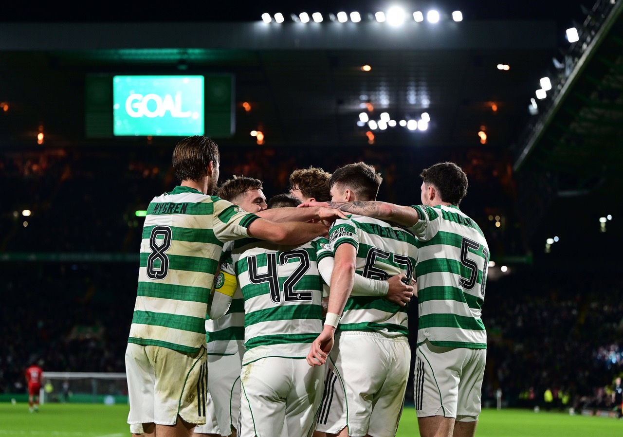Celtic players celebrate the third goal by James Forrest.