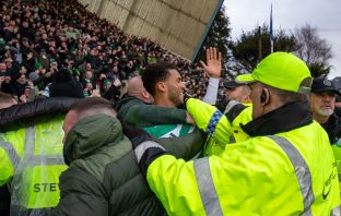 Auston Trusty celebrates with the Celtic supporters.