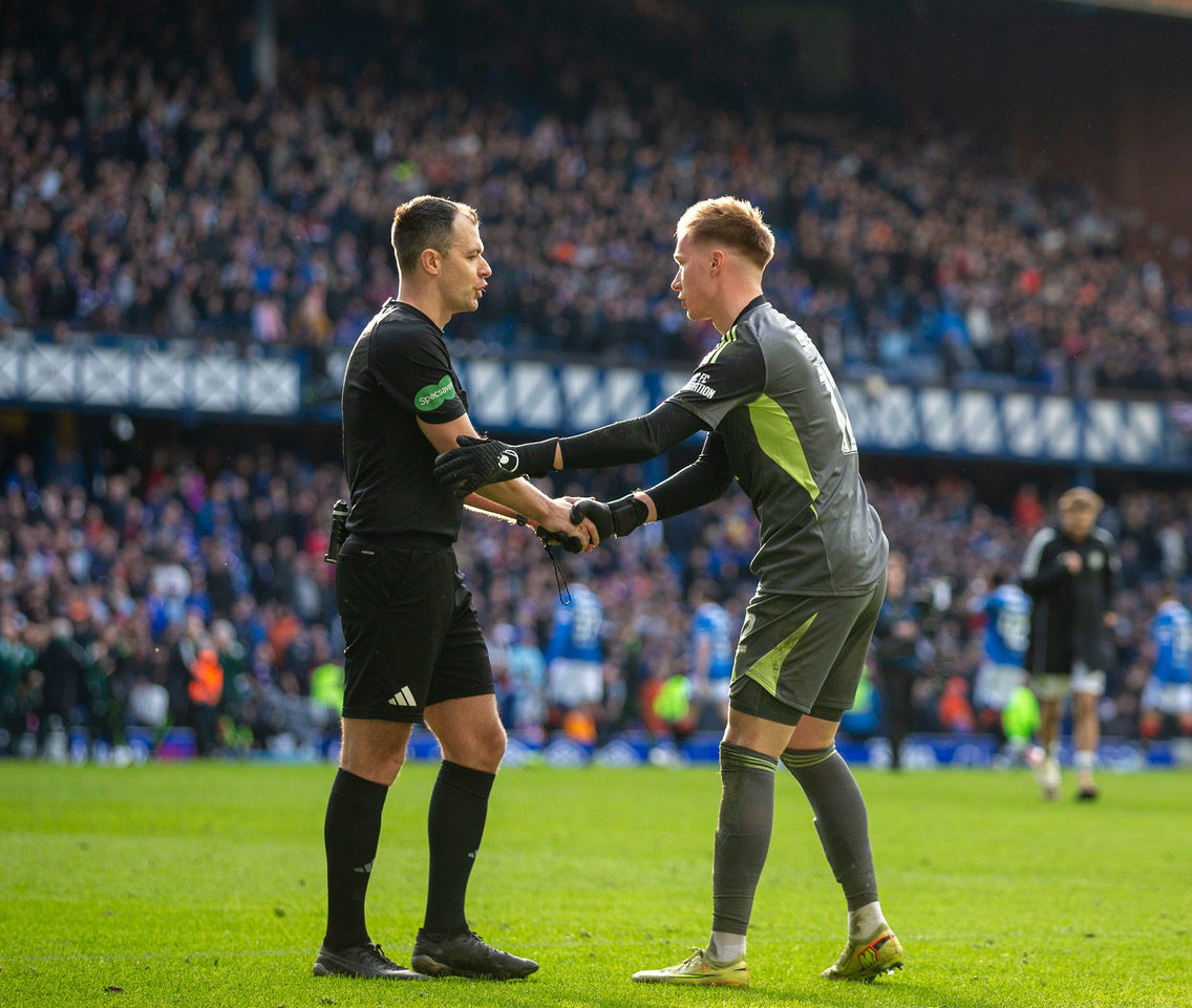 Referee Don Robertson and Viljami Sinisalo at the end of the penalty shoot-out.