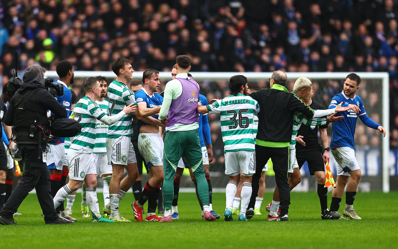 Celtic and theRangers players clash at the end of the game
